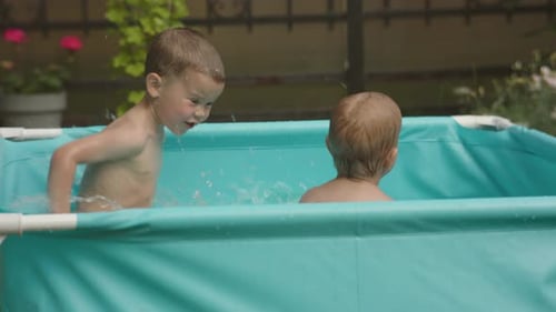 Kids in Pool Having Fun Happy Family Concept Two Male Siblings Splash in Water