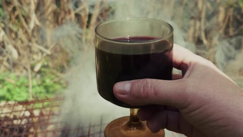 Wine in Hand by Grill with Smoke