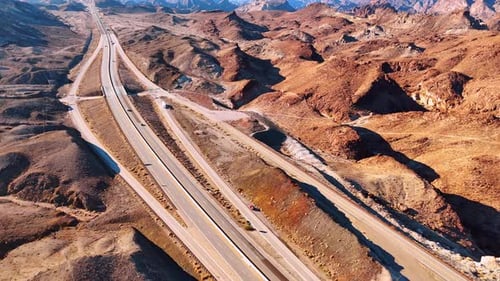 Desert Highway Aerial View with Mountain Backdrop