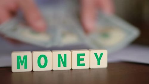 Concept of money and wealth. Selective focus and a person counting cash on the background.