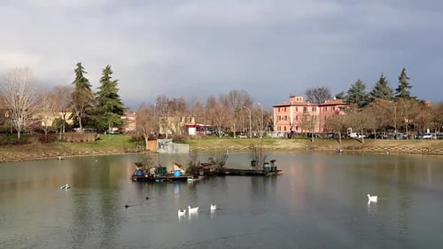Artificial lake in Bologna, Italy. Runners training on the shore