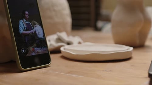 Female Sculptor Recording Process of Making Woman Bust on Smartphone
