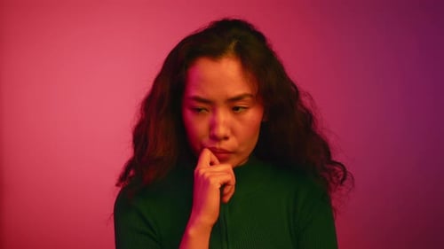 Thoughtful Woman Considering on Pink Background