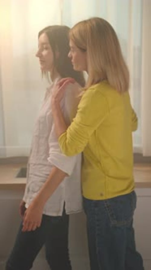 Affectionate Women Embrace at Home