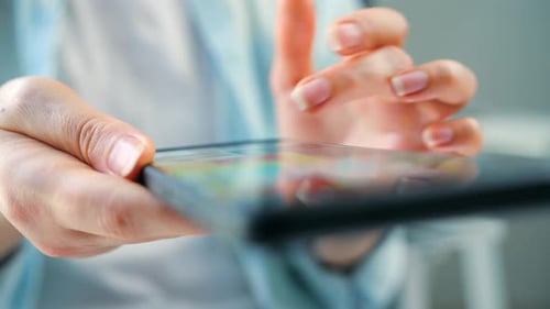 Woman Scrolling Through Social Media Feeds on Smartphone Close Up