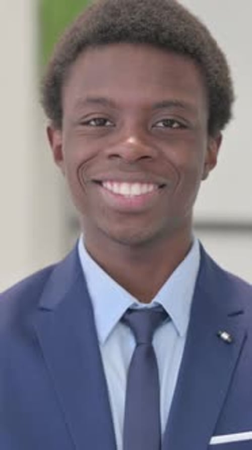 Smiling Young Man Giving Thumbs Up