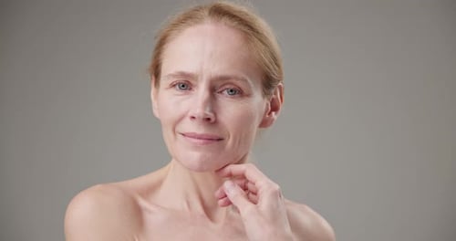 Mature Woman Smiling with Hand on Chin