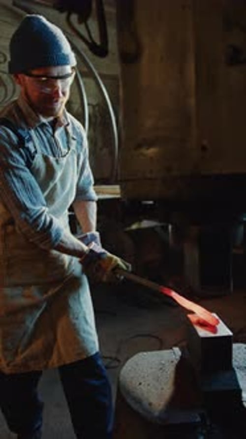 Blacksmith Working with Glowing Hot Metal on Anvil
