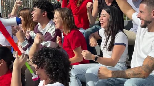 Excited Sports Fans Cheering for Their Team at Stadium