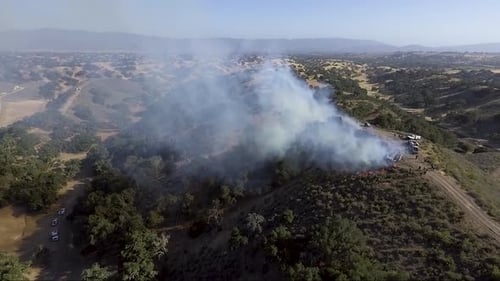 AERIAL - A control burn makes its way down the hillside
