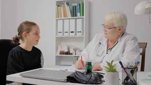 Professional pediatrician consulting caucasian girl in hospital.