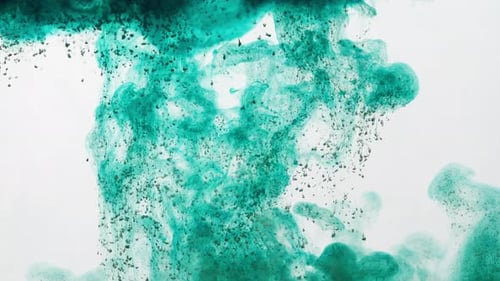 Green Dark Particles Seen Flowing And Dissolving In Clear Water. Abstract Artistic Shot