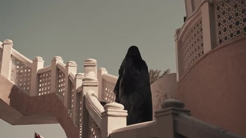 Woman Ascending Stairs Inside Mutrah Souq, Oman – Cinematic Market Scene