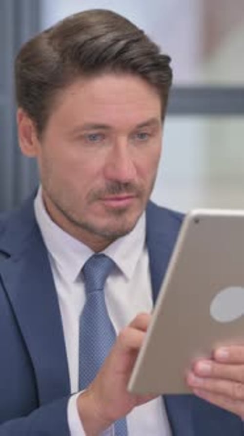 Man in Suit Using Digital Tablet Device