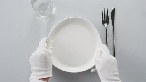 Flawless Table Setting with White Gloves Sophisticated Dining Experience Arrangement