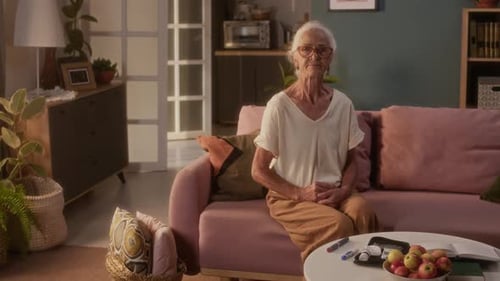 Senior Woman Sitting on Couch in Living Room