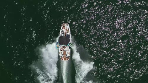 Speed boat with people roaring across the Sea at high speed
