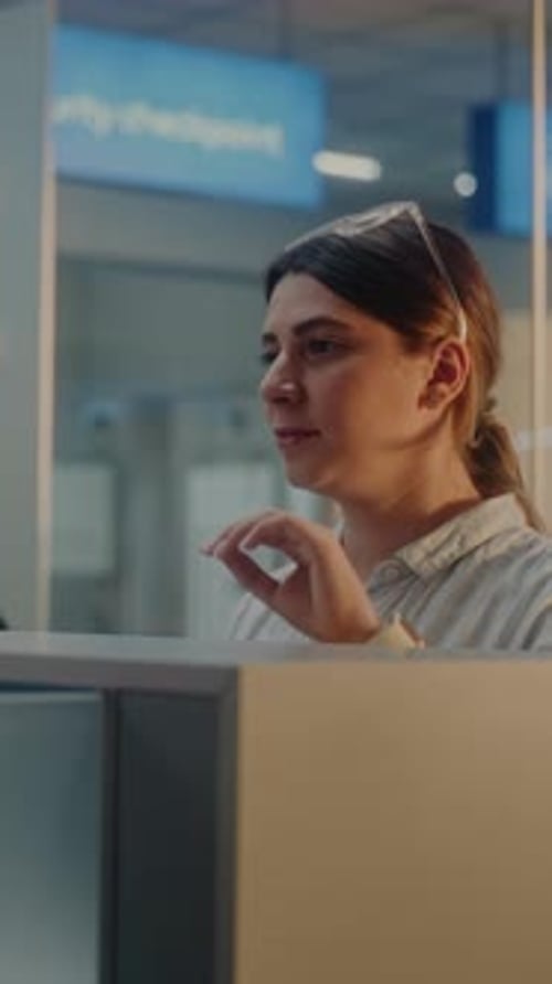 Multiethnic Passengers at Airport Checkin Counter Female Airline Worker Checking Documents