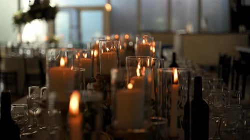 Close Up Scene of Lightening Candles in Glass Holders at the Celebration Party in the Venue