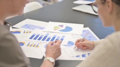 Rear View of Entrepreneurs Working on Documents