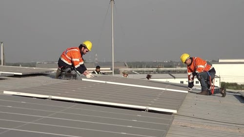 Solar energy and an engineering team on the roof of a building to install panel. Rooftop Solar cell.