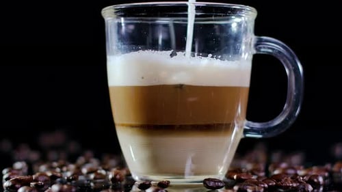 Closeup Cappuccino in Cup with Hot Milk Pouring Inside Mixing with Coffee Closeup Delicious Beverage