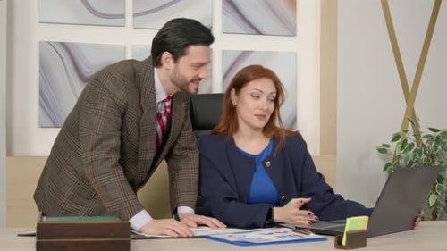 Diverse Business Colleagues with Laptop Analyzing Company Finance at Office