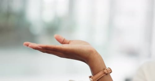 A woman hand open showing mockup space in the room of a modern building