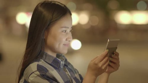 Happy Carefree Female Person Browsing on Mobile Smart Phone Tablet Screen