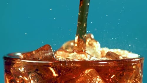 Refreshing Cola Pouring into Glass of Ice