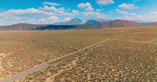 Nevada desert road aerial shot. Desert highway car driving.