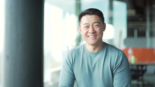 portrait of young asian man freelancer office worker teacher in modern room in casual clothes look