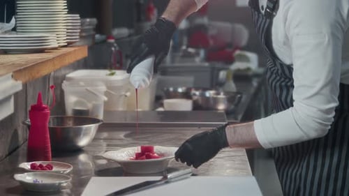 Chef Adding Flavour to Tuna Cubes in Restaurant Kitchen