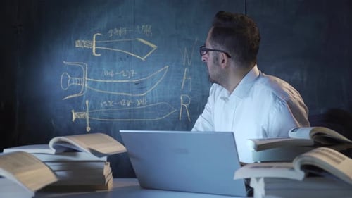 Historian man drawing swords on blackboard.