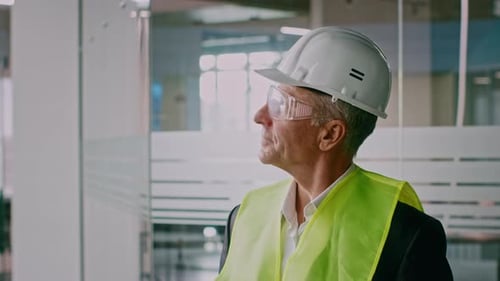 Senior Businessman Inspecting Corporate Office Environment with Safety Gear