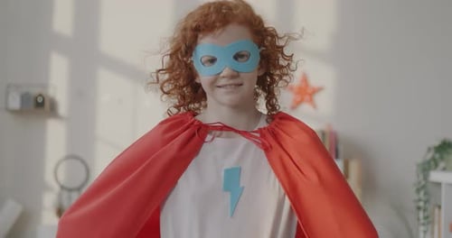 Happy Child Dressed as a Superhero Indoors