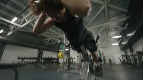 Muscular Man Performing Roman Chair Back Extensions in Gym