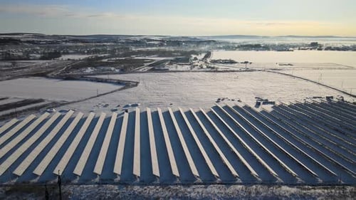 Aerial View of Sustainable Electrical Power Plant with Solar Photovoltaic Panels Covered with Snow