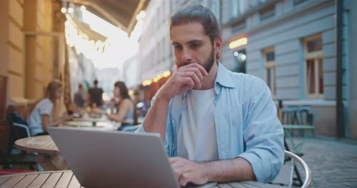 Confident Stylish Male Freelance Employee Working on Laptop Computer at College Destination Outdoors