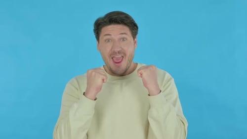 Man Celebrates Success with Clenched Fists