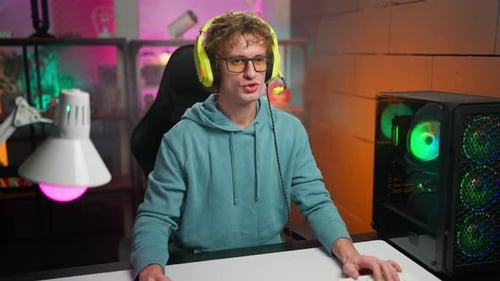 Young Adult Playing Video Games Online At Home