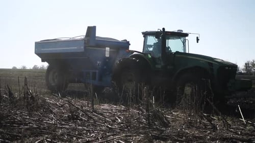 Tractor works with disc harrow on the field cultivating soil