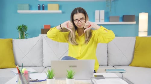 Woman Working At Home Gives Thumbs Down