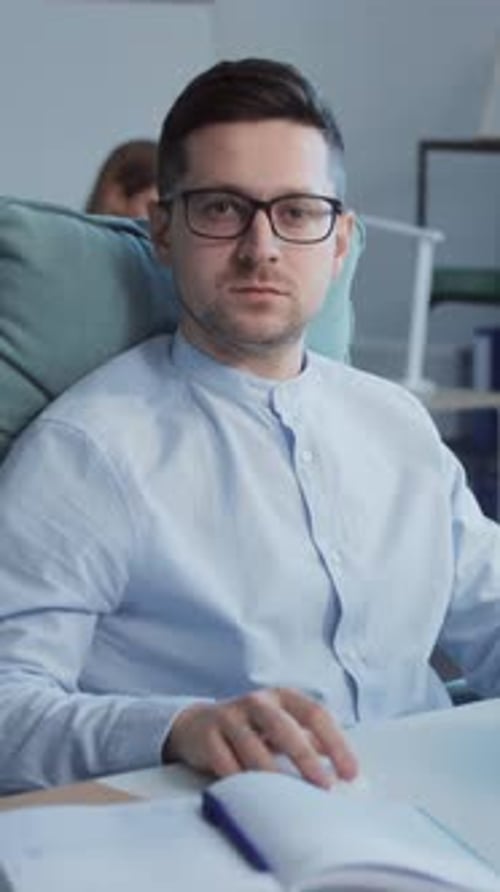 Portrait of Millennial Young Caucasian Man in Black Spectacles Using Computer at Workplace Footage
