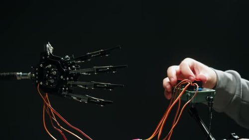 Modern Robotic Arm Holding and Moving Man Working with Mechanical Components Engineers Using Tablet