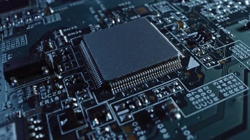 Focus on a Microchip, CPU Processor. Printed Circuit Board / Computer Motherboard with Components: