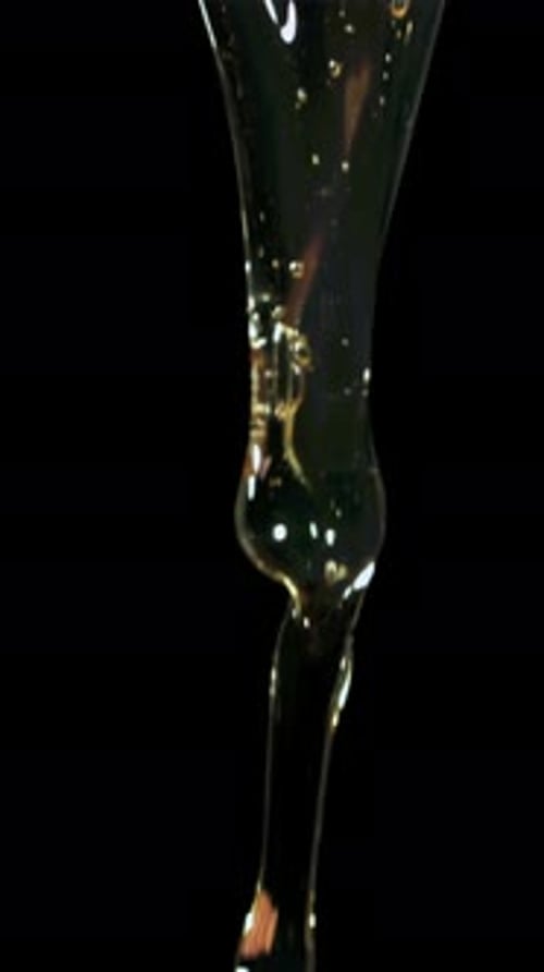Falling White and Yolk on a Black Background Filmed on a Highspeed Camera at 1000 Fps
