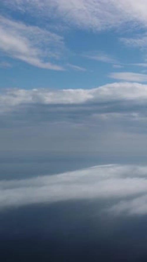 Aerial View Blue Sky Sun and Fog Over Calm Sea The Drone Flies Over Foggy and Fluffy Clouds Abstract