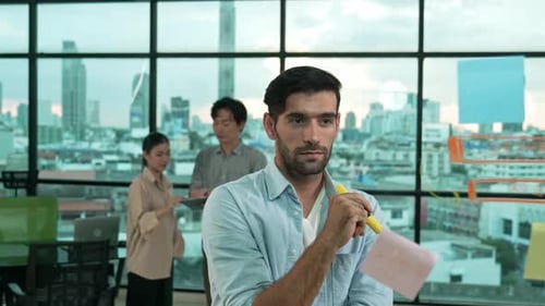 Business Team Planning Strategy on Glass Wall in Office
