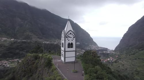 Aerial video above the tower church in Madeira Portugal overlooking the valley and the sea